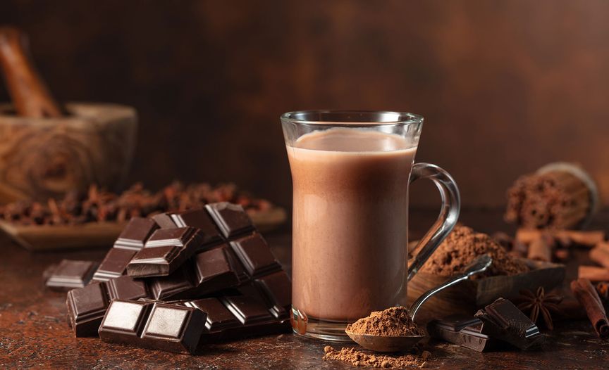 Chocolate and cocoa powder on a wooden table, surrounded by a warm, inviting atmosphere